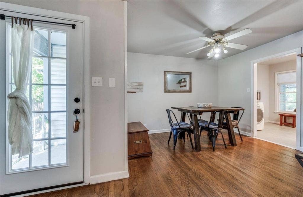 Wood-finish flooring, multi-light ceiling fan, and full-lite glass exterior door