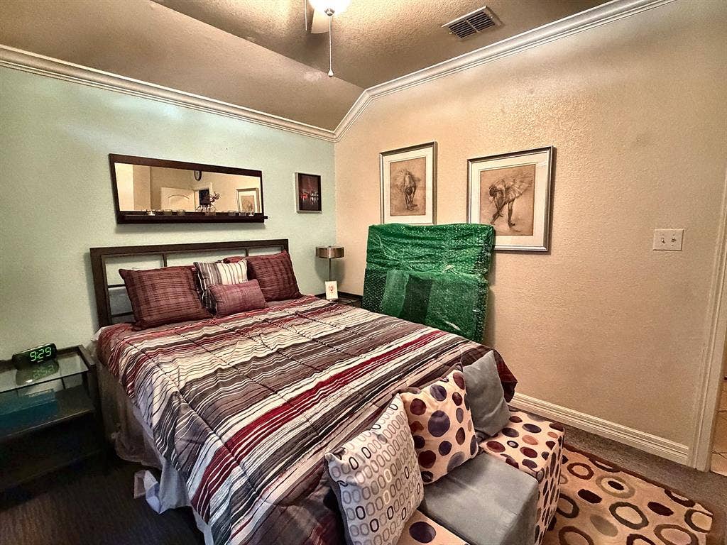 416 Wooded Creek Avenue, Wylie, TX 75098 Vaulted ceiling with crown molding and a centrally mounted ceiling fan