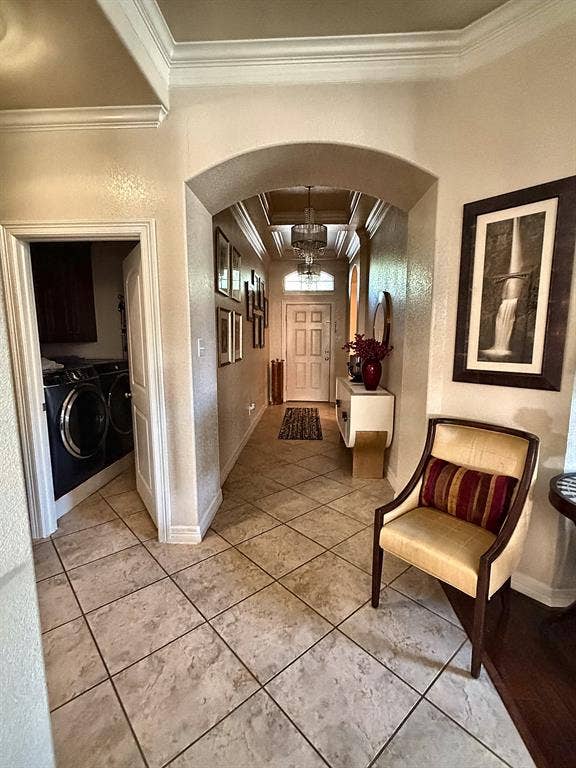 416 Wooded Creek Avenue, Wylie, TX 75098 Foyer featuring ceramic tile flooring, arched architectural detailing, crown molding, and recessed tray ceiling with a central chandelier