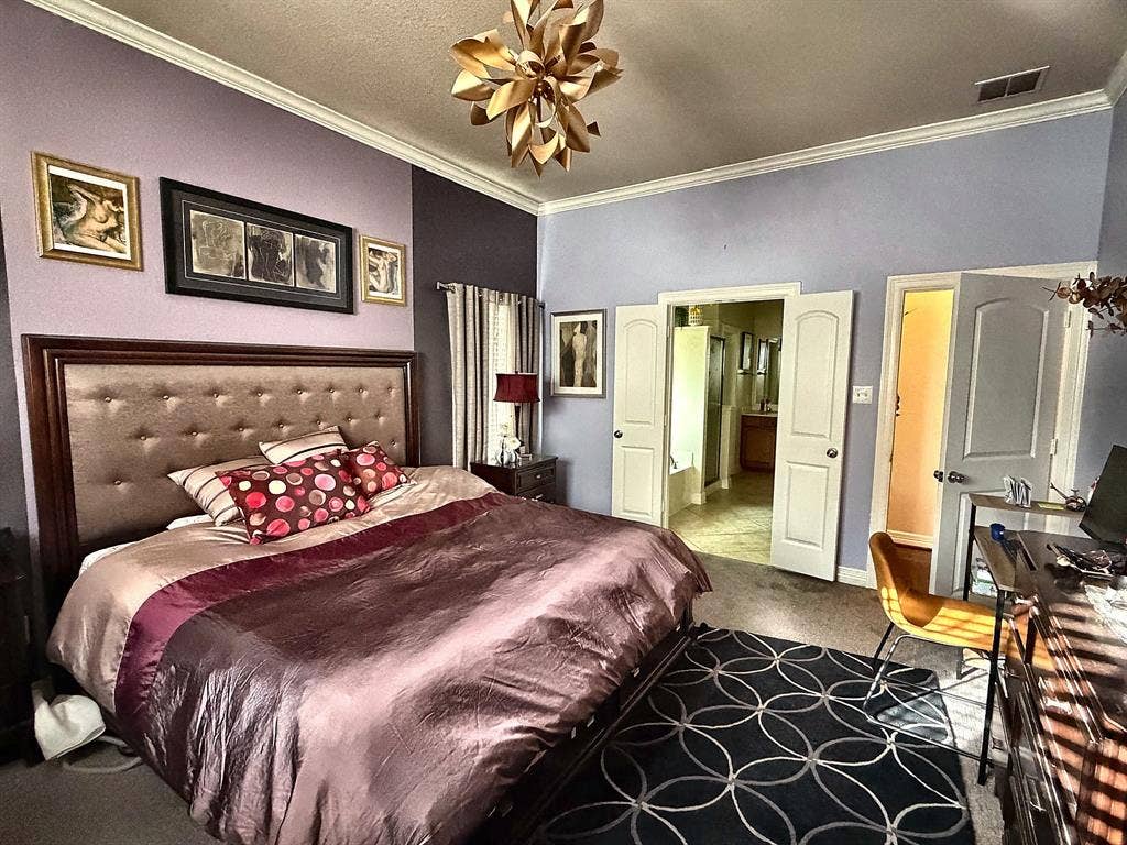416 Wooded Creek Avenue, Wylie, TX 75098 Bedroom featuring crown molding, neutral wall-to-wall carpeting, and a multi-tiered gold-tone geometric ceiling light fixture