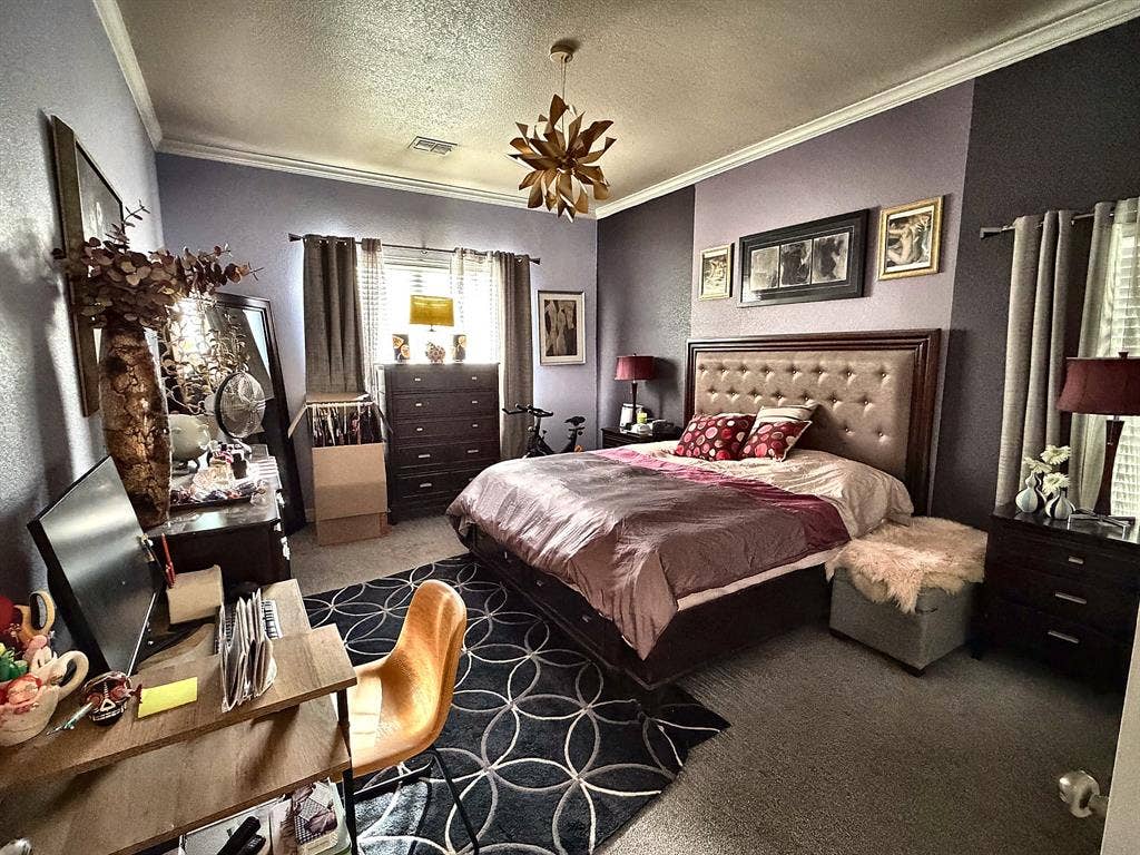 416 Wooded Creek Avenue, Wylie, TX 75098 Bedroom featuring crown molding, neutral wall-to-wall carpeting, and a geometric-style pendant light fixture