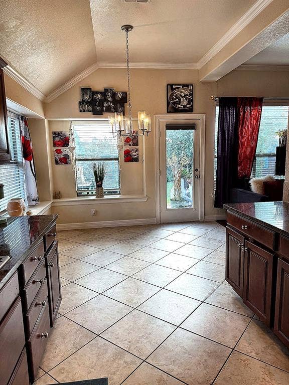 416 Wooded Creek Avenue, Wylie, TX 75098 Vaulted ceiling, built-in window seating, tile flooring, multi-light chandelier, and glass-paneled exterior door