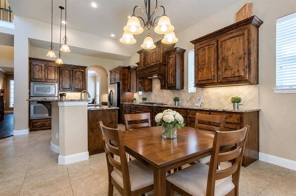 13812 Nash Lane, Frisco, TX 75035 Kitchen dining area featuring a square wood table and chairs, recessed lighting, and a multi-light chandelier