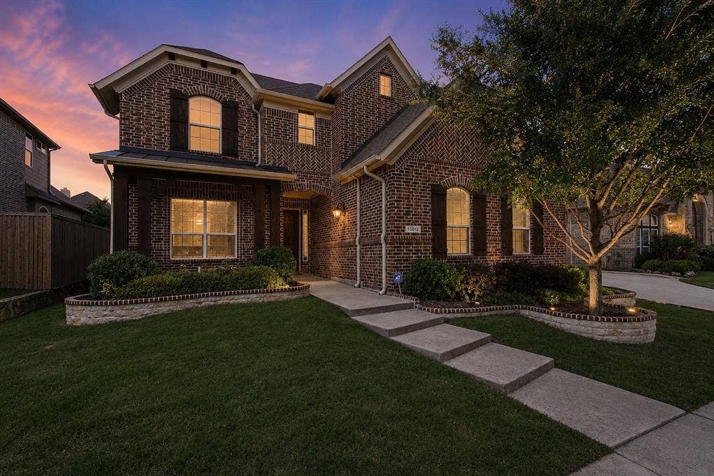 13812 Nash Lane, Frisco, TX 75035 Brick exterior with dark wood shutters and a gabled roof
