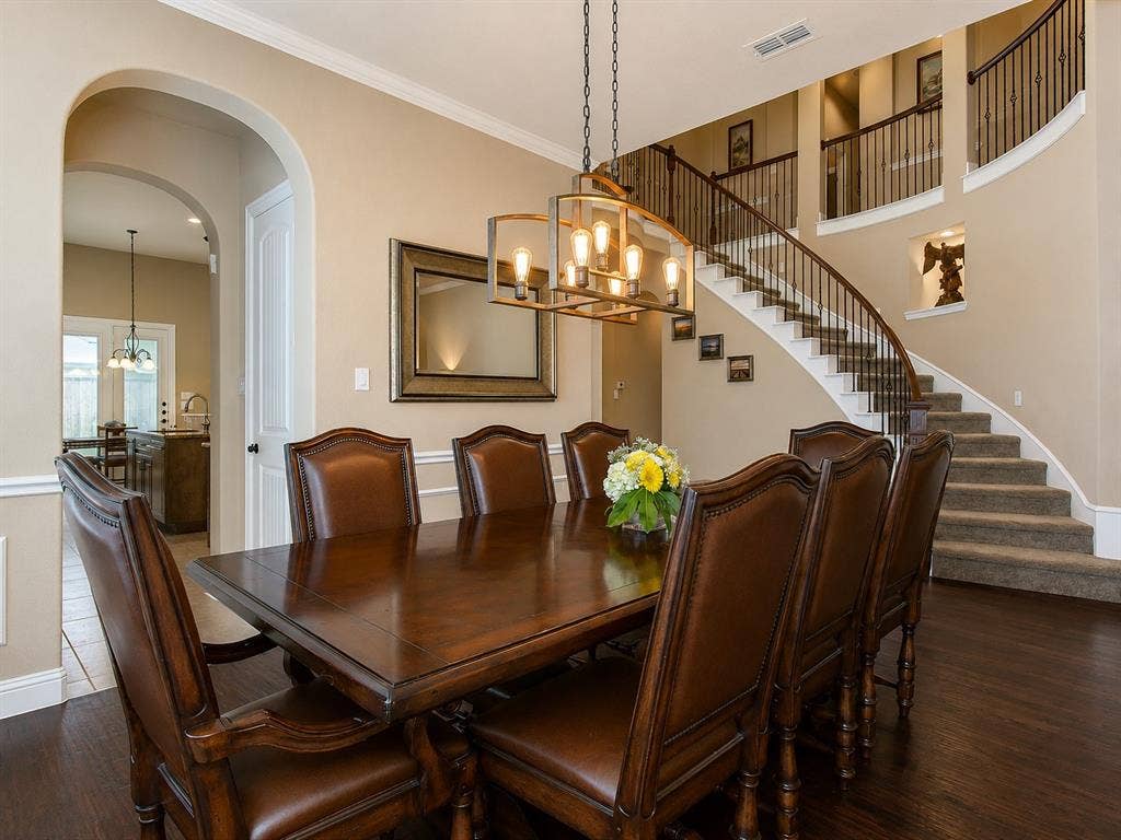 13812 Nash Lane, Frisco, TX 75035 Formal dining area featuring rich wood-finish flooring, an arched doorway, and a contemporary chandelier