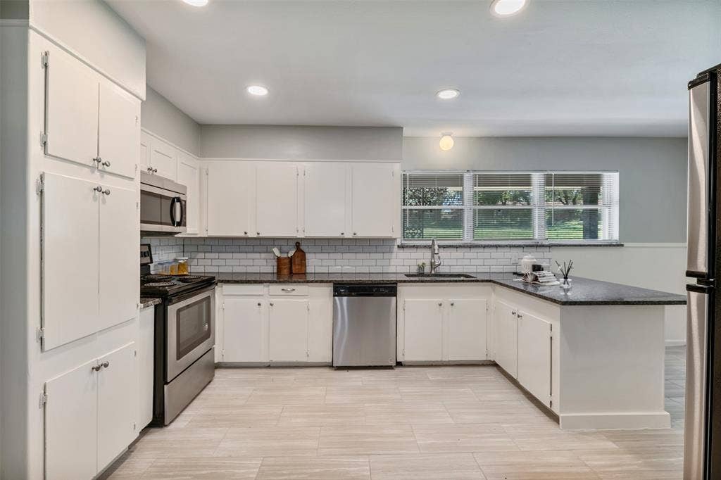 4516 Rolling Hills Drive, Fort Worth, TX 76119 The kitchen has granite counters and stainless appliances