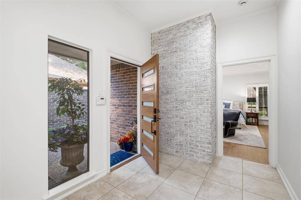4115 Brooktree Lane, Dallas, TX 75287 Bright foyer with a whitewashed brick accent wall—style greets you before you even set down your keys.