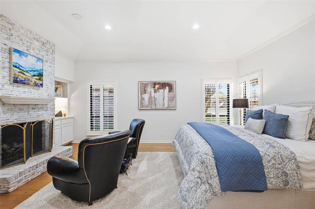 4115 Brooktree Lane, Dallas, TX 75287 Vaulted ceiling, fireplace, and plantation shutters—the primary suite is pure relaxation.