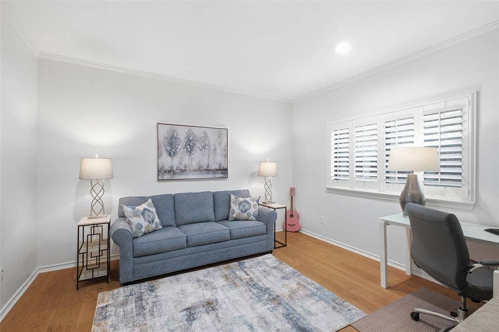 4115 Brooktree Lane, Dallas, TX 75287 Secondary bedroom with plantation shutters and wood floors—ideal as a guest room, office, or both.