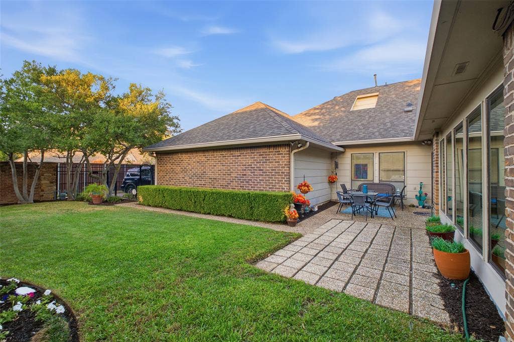 4115 Brooktree Lane, Dallas, TX 75287 Lush lawn, manicured hedges, and a patio right off the living room—room to garden, play, and unwind.