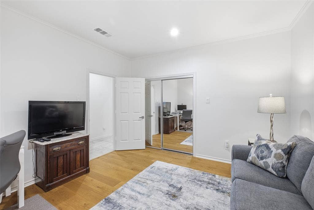 4115 Brooktree Lane, Dallas, TX 75287 Mirrored closet doors and wide-plank floors make this secondary bedroom bright and flexible.