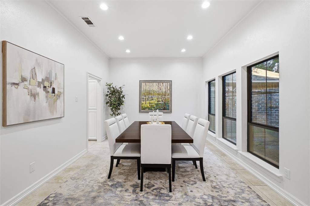 4115 Brooktree Lane, Dallas, TX 75287 A soaring ceiling and wall of windows fill the dining room with natural light. Made for lingering over dinner.