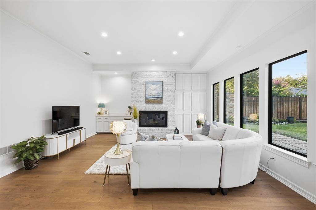 4115 Brooktree Lane, Dallas, TX 75287 Soaring ceilings and walls of glass frame the backyard greenery—movie nights and lazy Sundays have a new home.