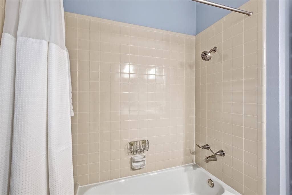 4115 Brooktree Lane, Dallas, TX 75287 Tub/shower combo in the hall bath, conveniently shared by the secondary bedrooms.
