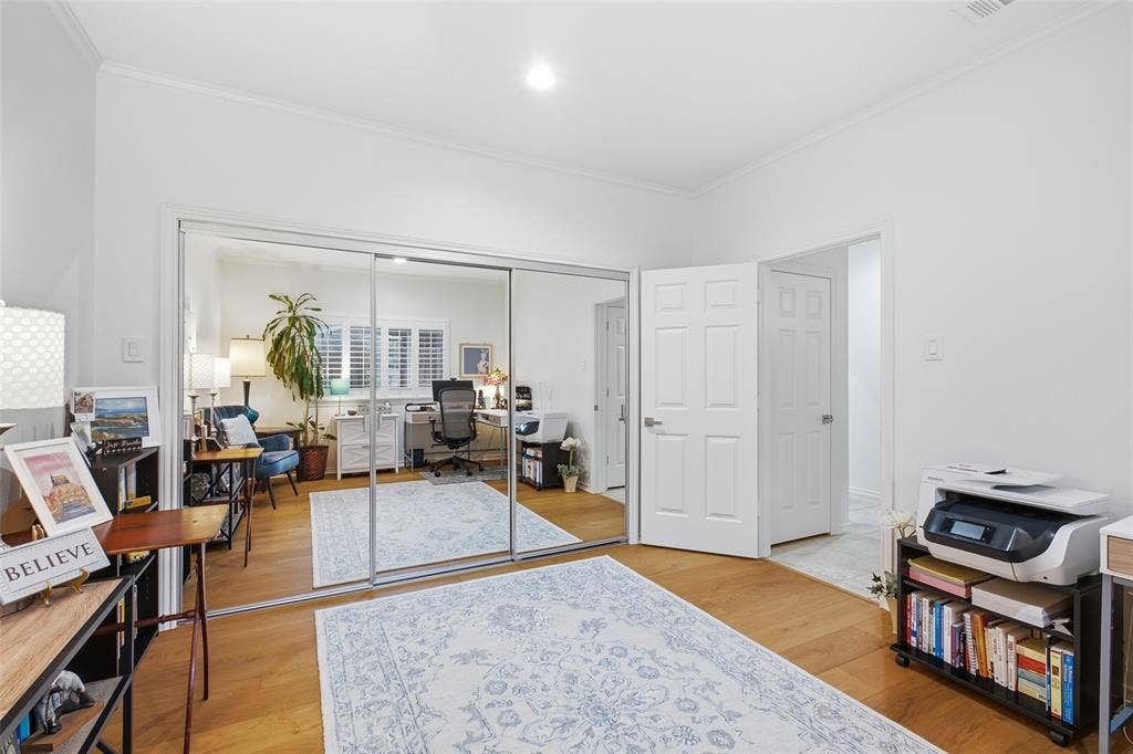 4115 Brooktree Lane, Dallas, TX 75287 Mirrored sliding closet doors and warm wood floors in this versatile third bedroom.