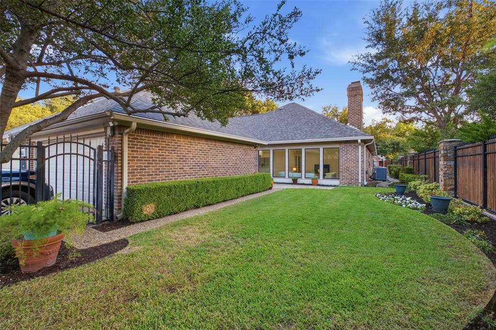4115 Brooktree Lane, Dallas, TX 75287 Gated drive to the two-car garage, plus a sweeping, tree-shaded backyard.