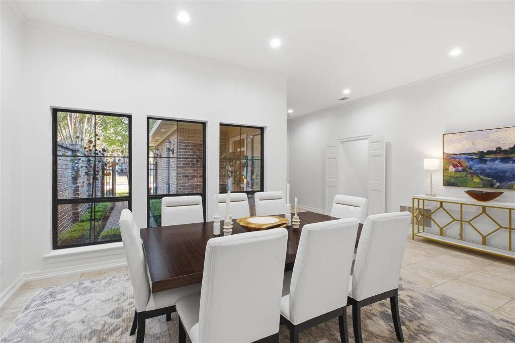 4115 Brooktree Lane, Dallas, TX 75287 Formal dining framed by courtyard-facing windows—holiday dinners and birthday celebrations, all set.