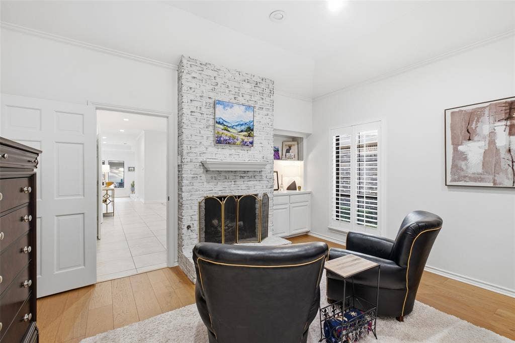 4115 Brooktree Lane, Dallas, TX 75287 Curl up by your own bedroom fireplace, framed by built-in shelving and plantation shutters.