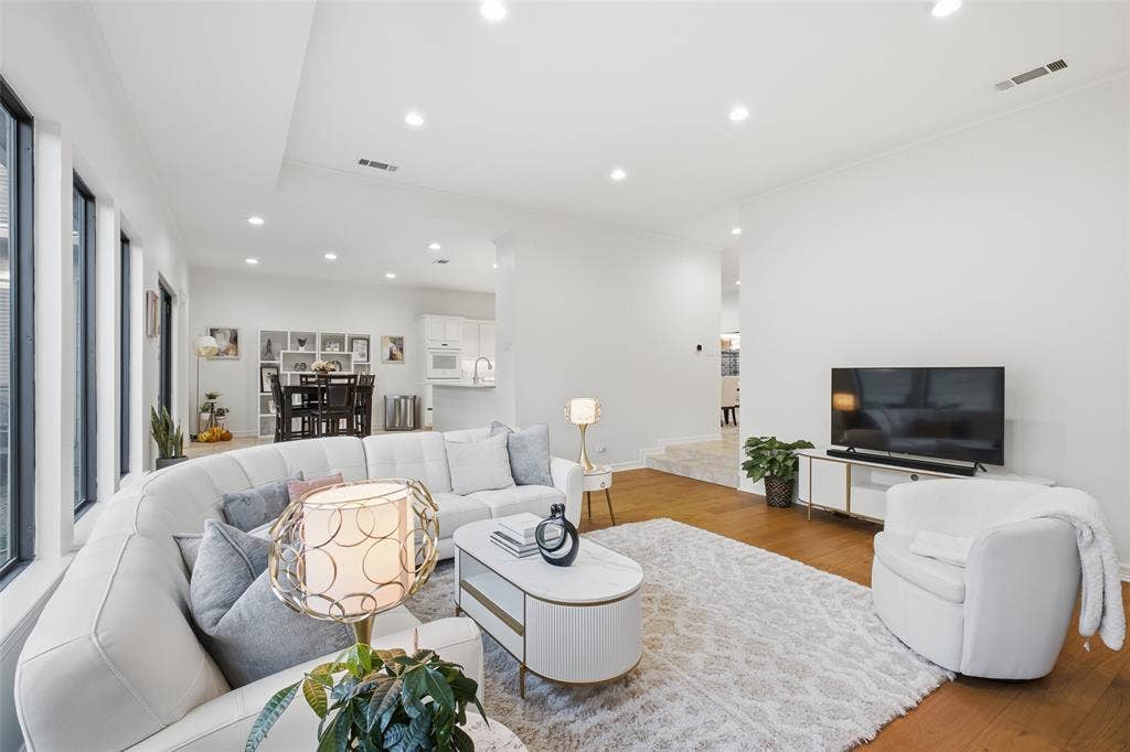 4115 Brooktree Lane, Dallas, TX 75287 Recessed lighting, crown molding, and wide-plank floors make the living space feel crisp, airy, and move-in ready.