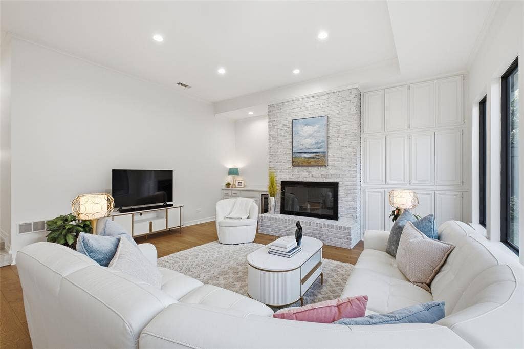 4115 Brooktree Lane, Dallas, TX 75287 Floor-to-ceiling built-in cabinetry flanks the linear fireplace for storage and style in the heart of the home.