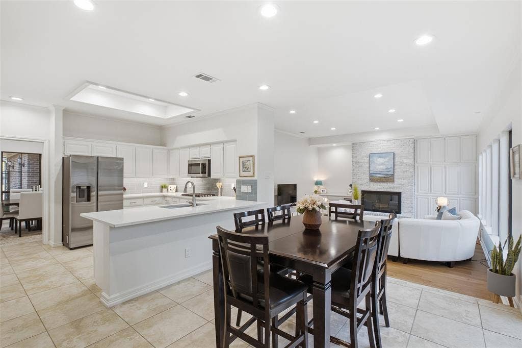 4115 Brooktree Lane, Dallas, TX 75287 Kitchen, nook, and living room connect in one open sightline—made for hosting a crowd or a quiet night in.