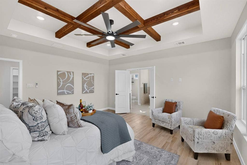 102 Nicklaus Drive, Sulphur Springs, TX 75482 Coffered ceiling featuring wood-finish beams, integrated recessed lighting, and a centralized matte black multi-blade ceiling fan, complemented by wood-finish flooring