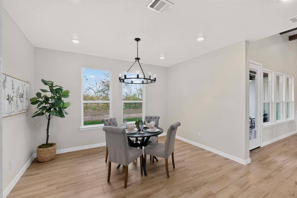 102 Nicklaus Drive, Sulphur Springs, TX 75482 Dining area featuring wood-finish flooring, recessed lighting, a circular iron chandelier, and multiple paneled windows
