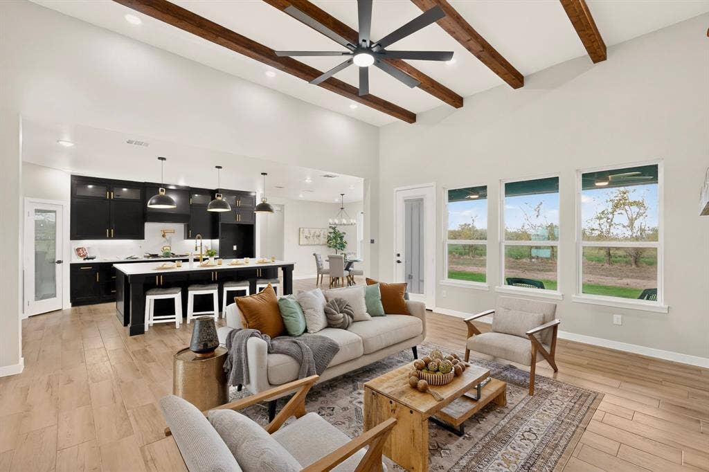 102 Nicklaus Drive, Sulphur Springs, TX 75482 Vaulted ceiling with exposed wood beams, wood-finish flooring, and a kitchen featuring contrasting cabinetry, a center island with pendant lighting, and recessed ceiling lights