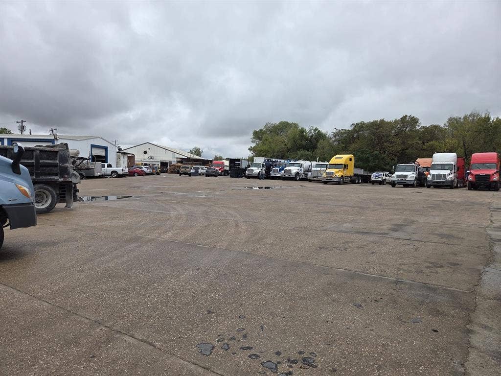 2311 Cartwright Street, Dallas, TX 75212 Expansive paved industrial lot featuring multiple metal-clad structures