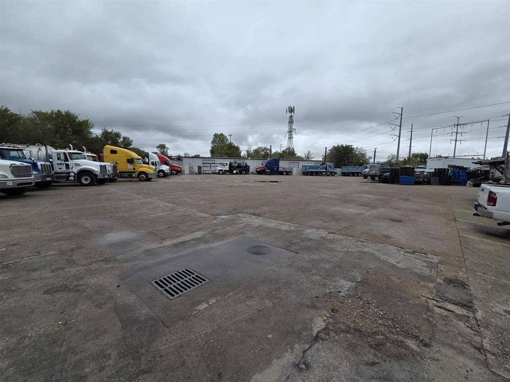 2311 Cartwright Street, Dallas, TX 75212 Expansive concrete industrial lot featuring integrated drainage systems and perimeter fencing