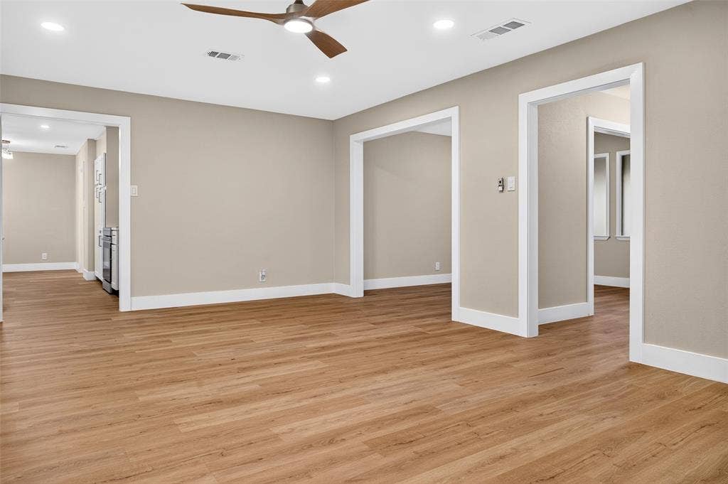 Neutral interior featuring wood-finish flooring, recessed lighting, and a modern ceiling fan