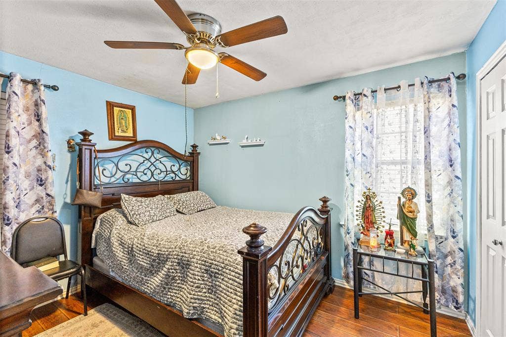 1801 Pleasant Run Road, Carrollton, TX 75006 Wood-finish flooring, ceiling fan with integrated lighting, and white six-panel closet door