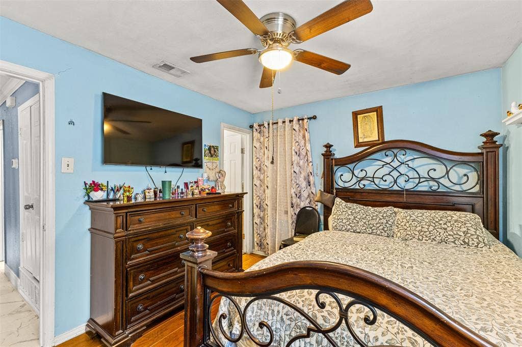 1801 Pleasant Run Road, Carrollton, TX 75006 Interior room featuring wood-finish flooring and a central ceiling fan with an integrated light fixture