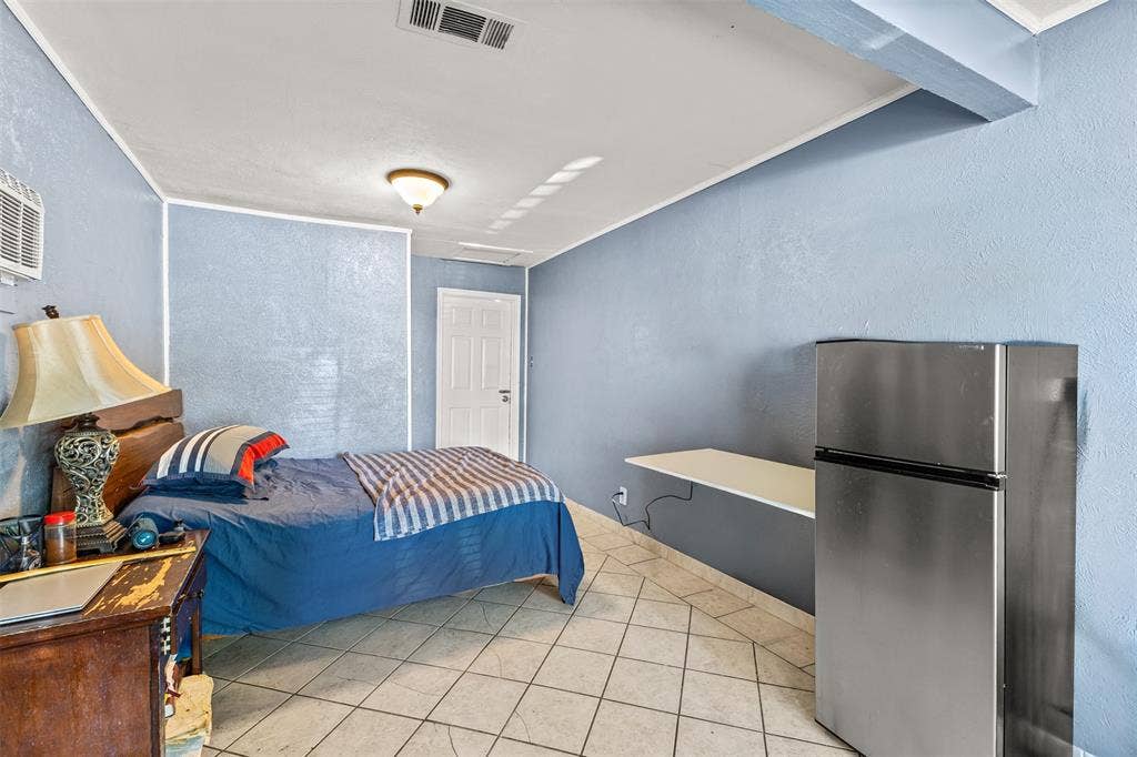 1801 Pleasant Run Road, Carrollton, TX 75006 Interior space featuring diagonal ceramic tile flooring, a wall-mounted counter surface, and a single-panel interior door
