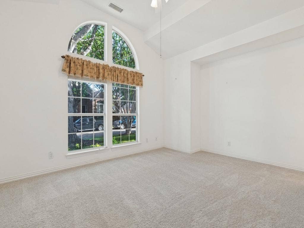 2817 Mayfair Lane, McKinney, TX 75071 High ceilings featuring an arched window, white walls, and carpeted flooring