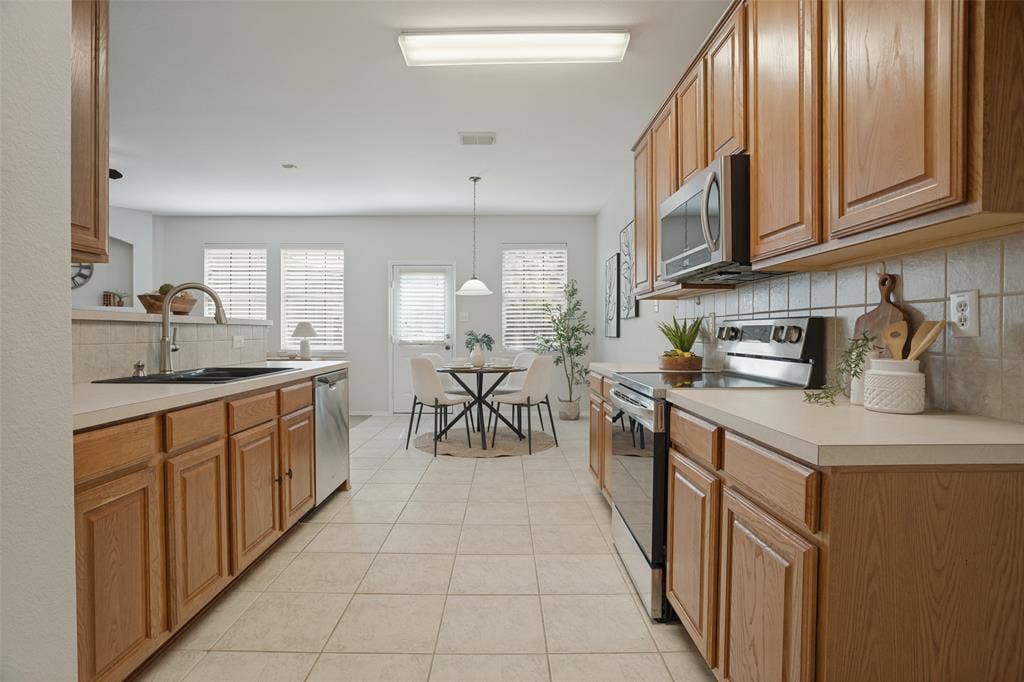 Kitchen with abundant cabinetry, stainless steel appliances and breakfast area