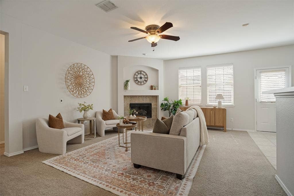 Light-filled living room with tiled fireplace and backyard-facing
