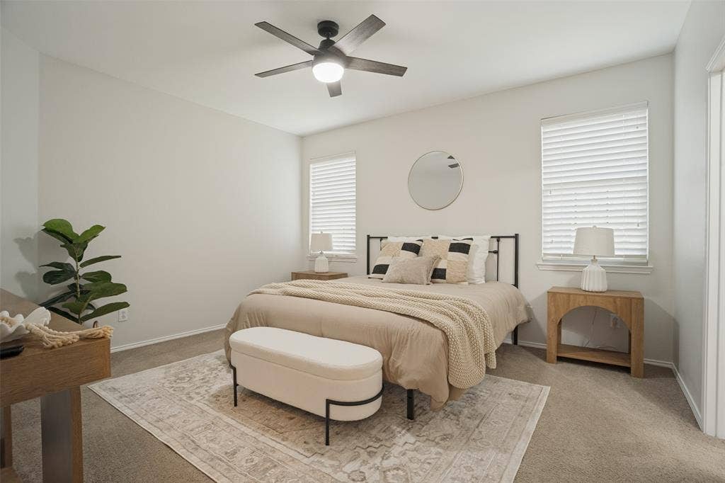 Additional primary bedroom view with windows and comfortable layout