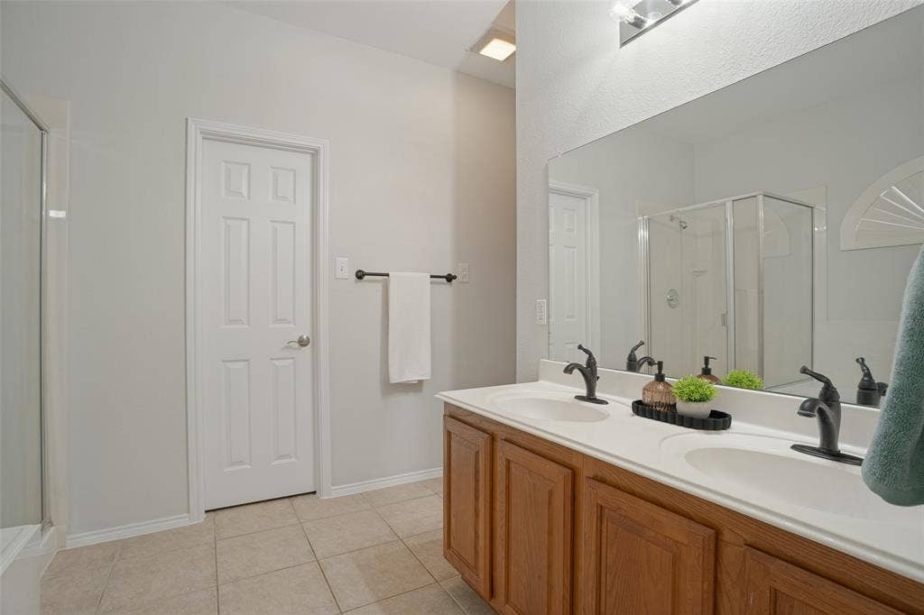 Primary bathroom with dual sinks and ample vanity storage