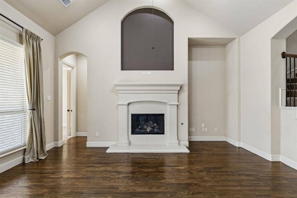 6448 Fire Creek Trail, Frisco, TX 75036 Vaulted ceilings, wood-finish flooring, and a fireplace with a custom mantel