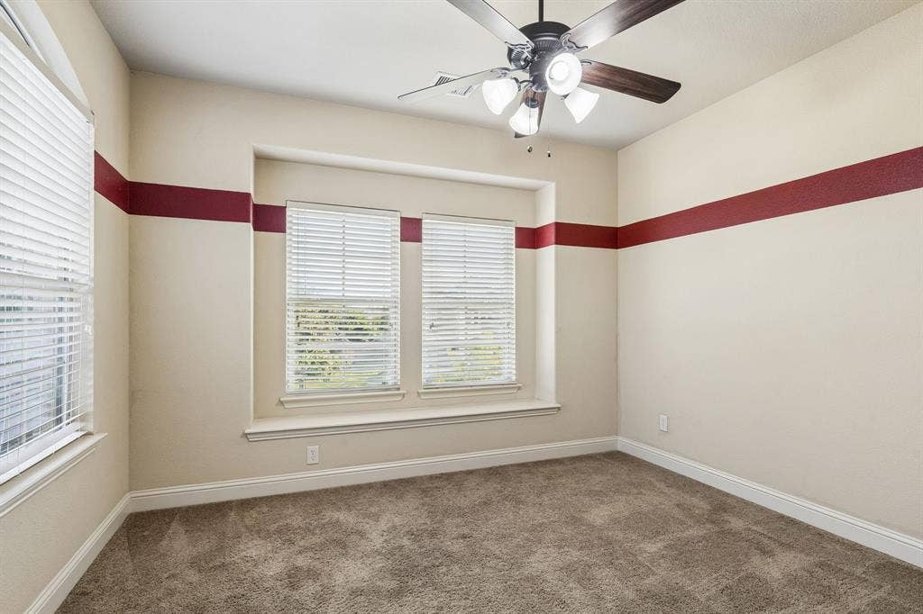 6448 Fire Creek Trail, Frisco, TX 75036 Recessed window nook featuring dual windows with horizontal blinds, neutral wall-to-wall carpeting, and a central ceiling fan with multi-light fixture