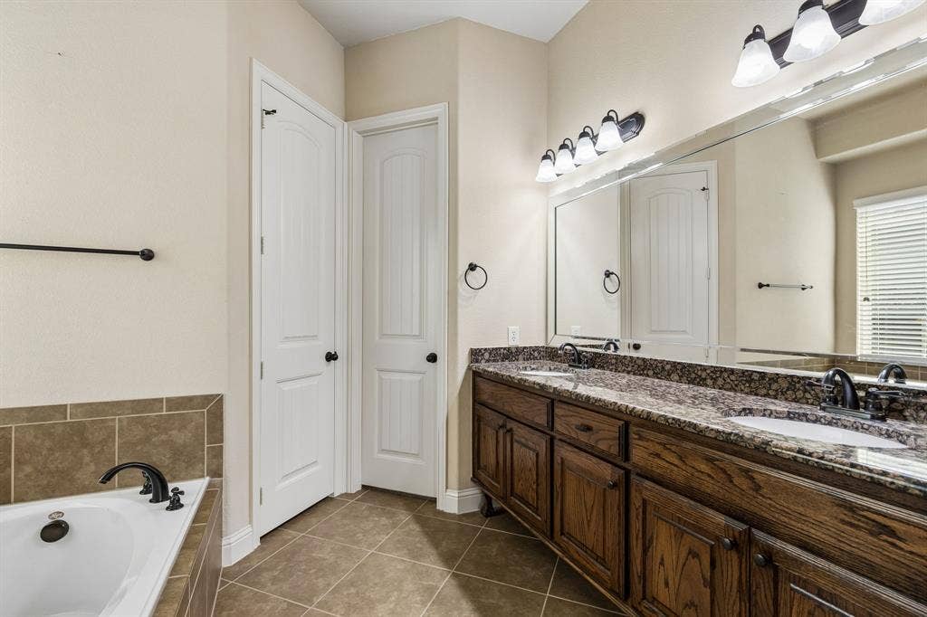 6448 Fire Creek Trail, Frisco, TX 75036 Dual-sink vanity with stone-finish countertop, undermount sinks, and oil-rubbed bronze faucets