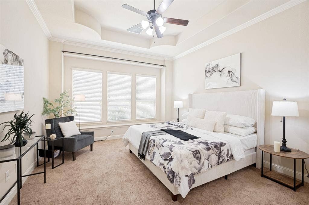 6448 Fire Creek Trail, Frisco, TX 75036 Tray ceiling featuring crown molding, triple window configuration, and an integrated ceiling fan