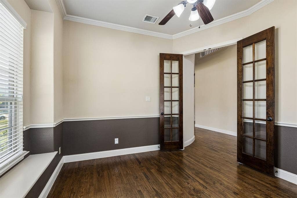6448 Fire Creek Trail, Frisco, TX 75036 Room featuring wood-finish flooring, two-tone wall paint, built-in window seat, crown molding, and wooden French doors with glass panes