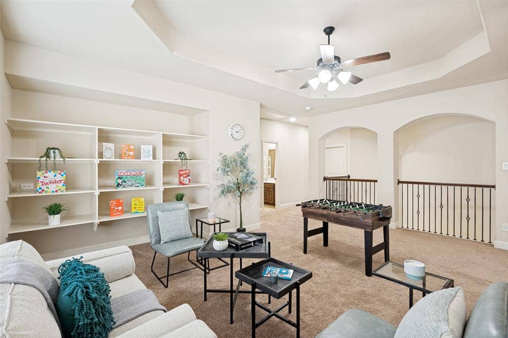 6448 Fire Creek Trail, Frisco, TX 75036 Tray ceiling with integrated lighting, built-in shelving, and metal stair railing