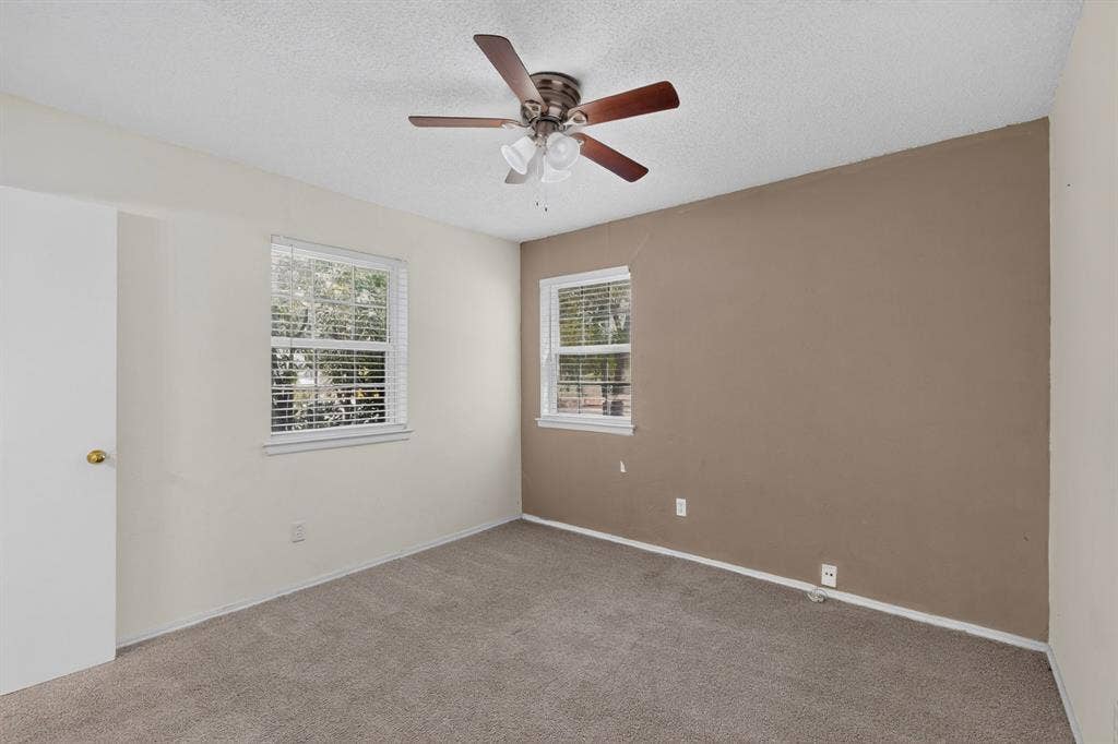 9651 Cherry Street, Frisco, TX 75033 Interior space featuring carpeting, a ceiling fan with integrated lighting, and two windows with fitted blinds