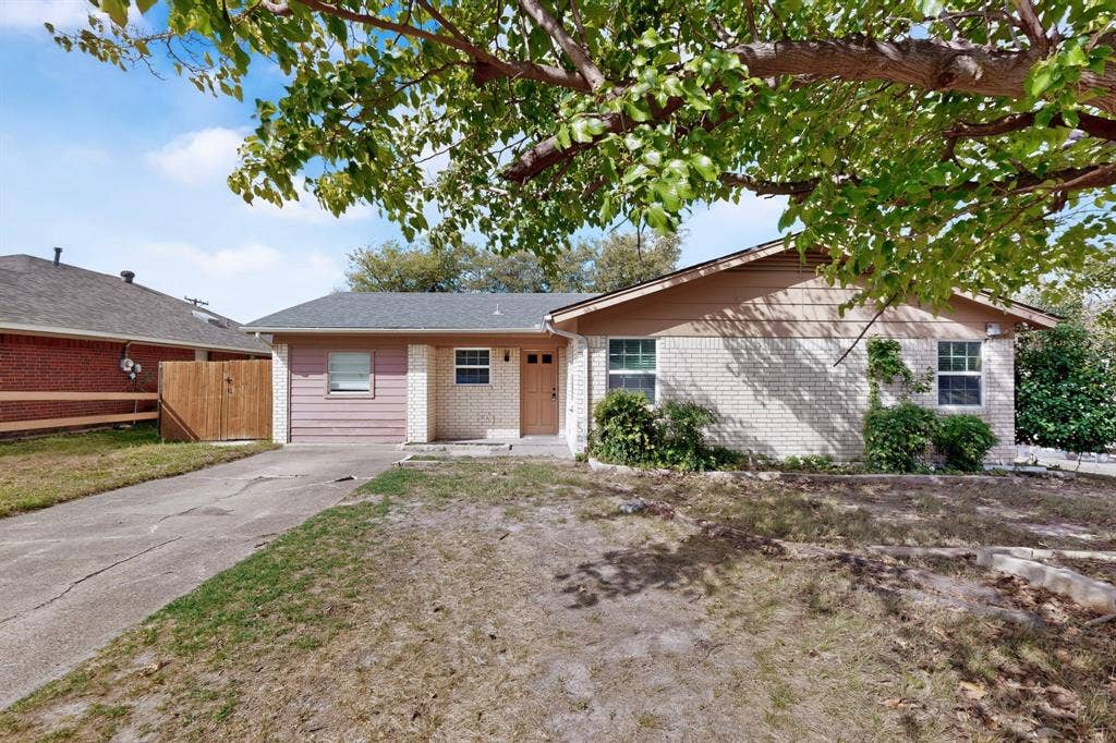 9651 Cherry Street, Frisco, TX 75033 Single-story exterior featuring a brick and horizontal siding facade, a paved driveway, and mature landscaping