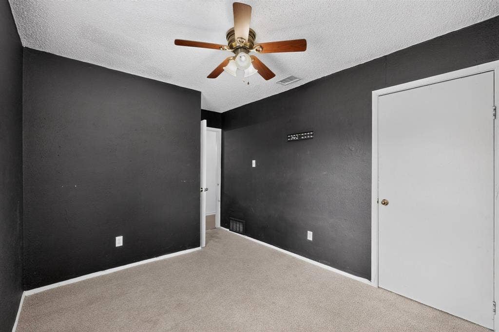 9651 Cherry Street, Frisco, TX 75033 Neutral-toned carpeting, ceiling-mounted paddle fan with integrated light fixture, and solid-core interior doors