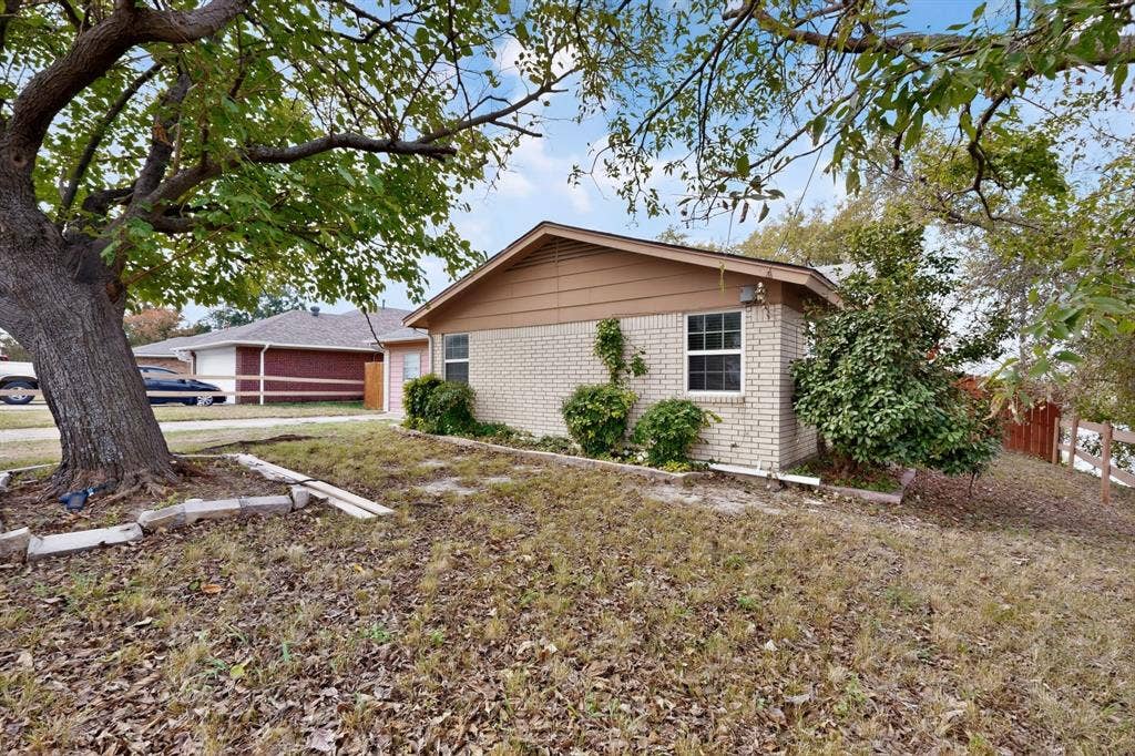 9651 Cherry Street, Frisco, TX 75033 Exterior featuring a brick and siding facade, low-pitched roofline, and mature trees