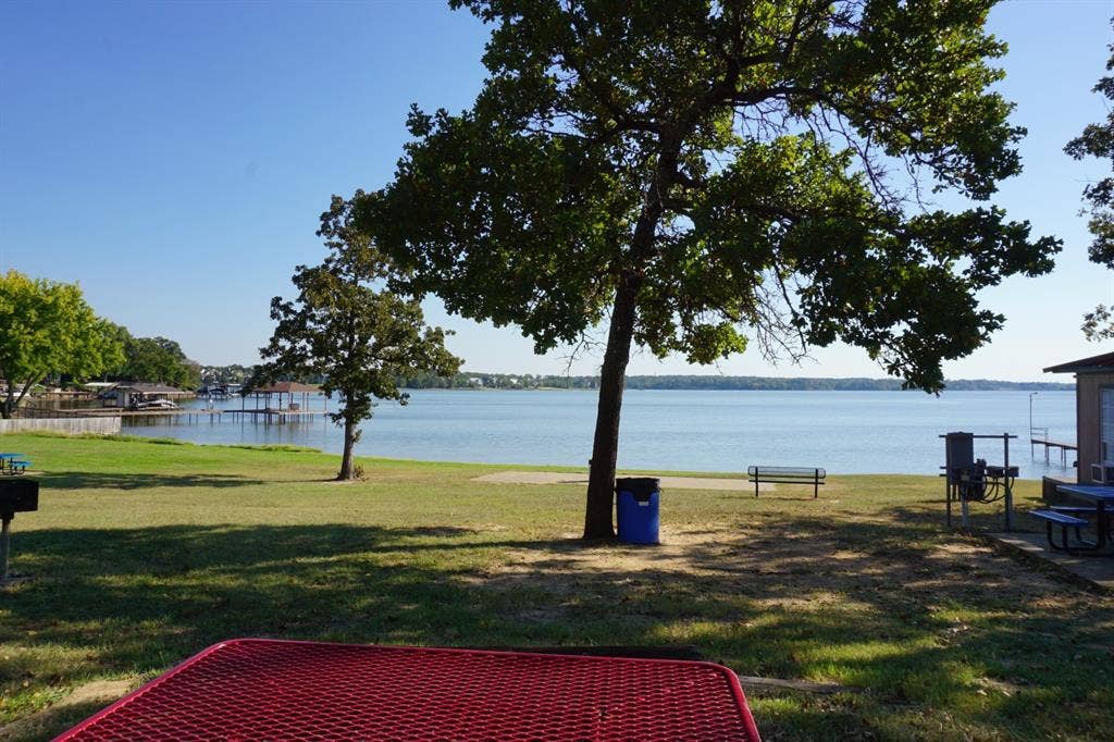 1688 Doc Holiday Dr, Log Cabin, TX 75148 View of green lawn with a water view and a patio